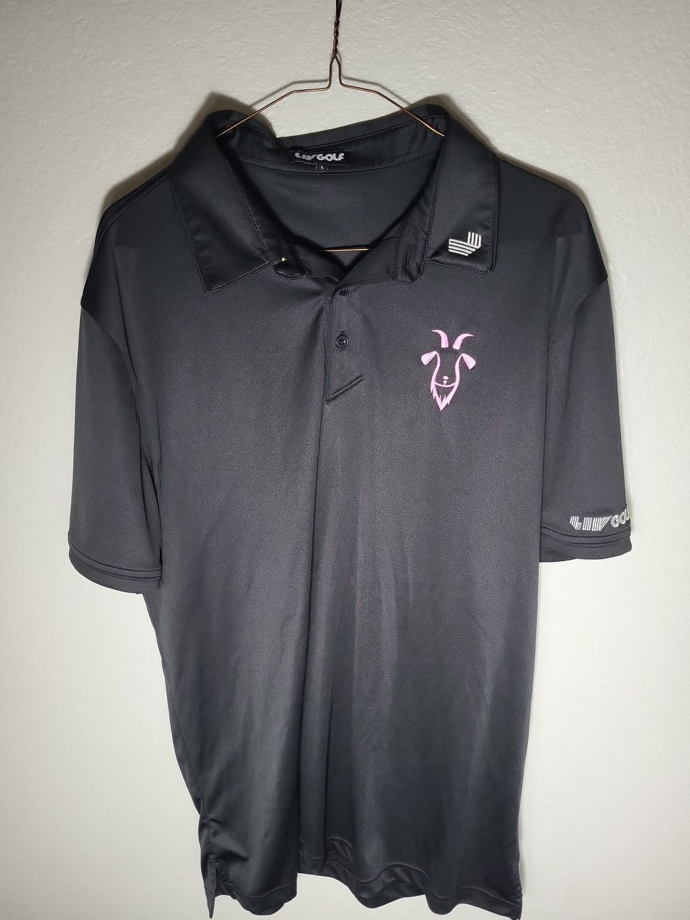 LIV GOLF Black Men's Golf Polo with Pink Logo Swannie Goat